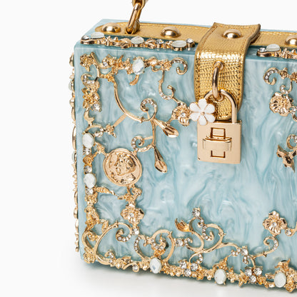Bolso rígido tipo box con detalles florales