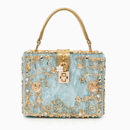 Bolso rígido tipo box con detalles florales